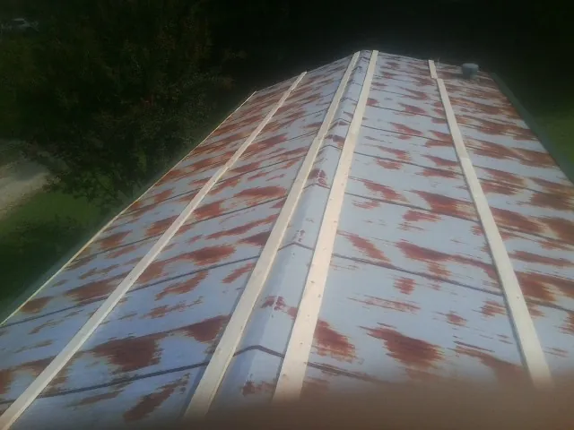 Rusted metal roof panels with new wood purlins before replacement — Storm Damage Roof Repair in Pingree by Roofing Brothers